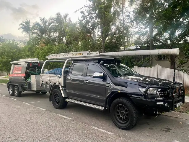 A dark ute towing a tradie trailer, from the Skeene Facebook cover photo